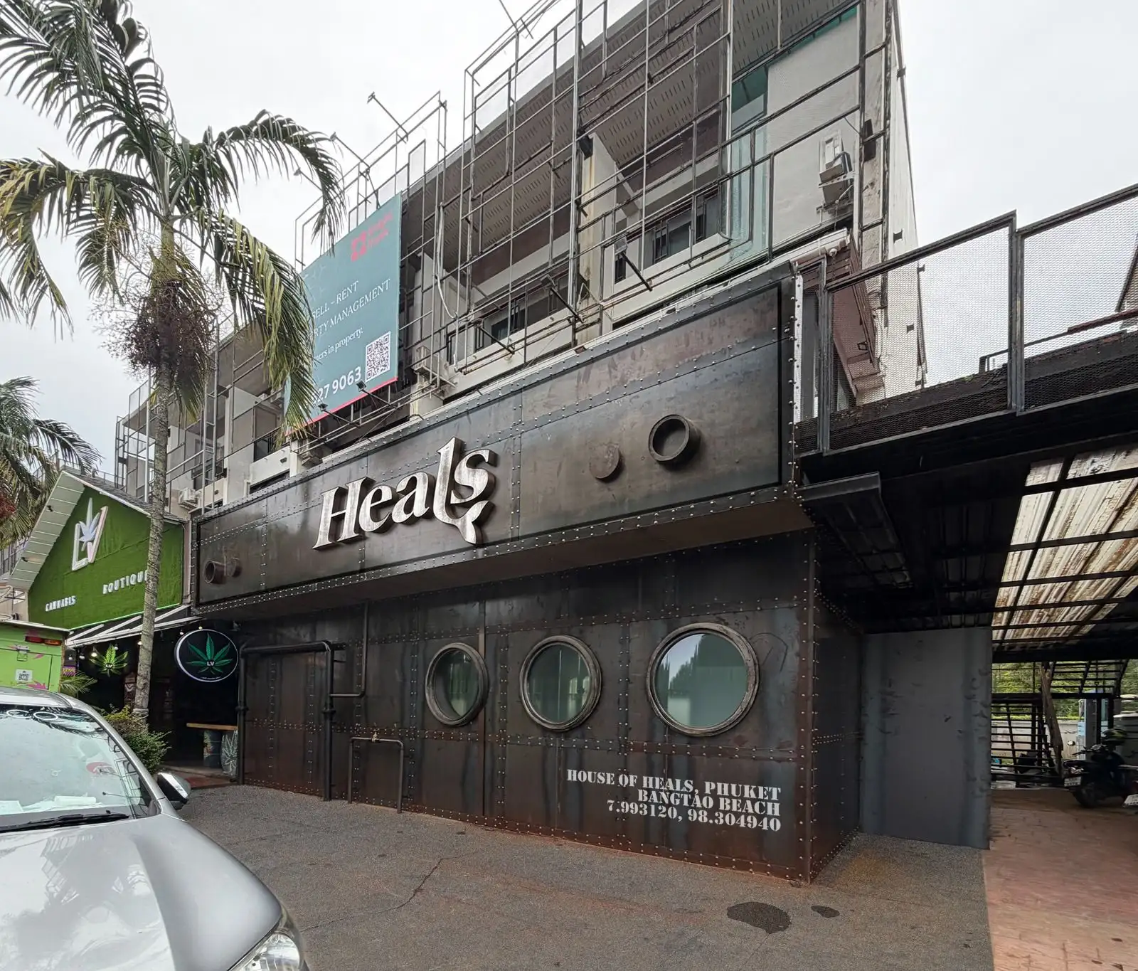 The same façade by day: raw steel and chrome letters